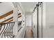 Upstairs hallway featuring hardwood floors, white walls, exposed wood beams and sliding barn doors at 645 Manor Rd, Maitland, FL 32751