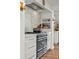 Close-up of a range and marble countertops in the kitchen, featuring ample storage at 645 Manor Rd, Maitland, FL 32751