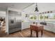 Charming kitchen with white cabinets, stainless steel fridge, and hardwood floors at 645 Manor Rd, Maitland, FL 32751