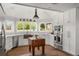 Bright kitchen features white cabinets, stainless steel appliances, and a butcher block island at 645 Manor Rd, Maitland, FL 32751