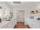 White kitchen with marble countertops, custom cabinetry, and wood flooring at 645 Manor Rd, Maitland, FL 32751