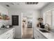 Well-lit kitchen with marble counters, custom cabinets, and stainless steel appliances at 645 Manor Rd, Maitland, FL 32751