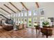 Expansive living room with high ceilings, piano, and brick floors for a bright space at 645 Manor Rd, Maitland, FL 32751