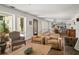 Spacious living room features wood floors and large windows, seamlessly connecting indoor and outdoor living spaces at 645 Manor Rd, Maitland, FL 32751