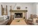 Inviting living room with a brick fireplace, wooden accents, and comfortable furnishings at 645 Manor Rd, Maitland, FL 32751