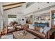 Spacious living room with brick floors, leather seating, and an open floor plan for entertaining at 645 Manor Rd, Maitland, FL 32751