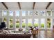Bright living room with beamed ceilings, lake views, and brick floors for added appeal at 645 Manor Rd, Maitland, FL 32751