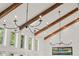 Bright living room boasting exposed wooden beams, large windows, and modern light fixtures at 645 Manor Rd, Maitland, FL 32751