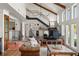 Beautiful living room with bar area, beamed ceilings, brick flooring, and an open floor plan at 645 Manor Rd, Maitland, FL 32751