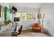 Bright office with windows, hardwood floors, accent rug and fun vintage furniture at 645 Manor Rd, Maitland, FL 32751