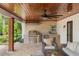 Covered outdoor kitchen featuring stainless steel appliances, seating, and stone accents at 645 Manor Rd, Maitland, FL 32751