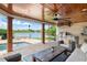 Outdoor kitchen and dining area with a view of the lake and swimming pool at 645 Manor Rd, Maitland, FL 32751
