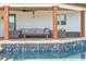 Covered patio featuring wood columns, a ceiling fan, an outdoor seating area and direct access to the pool at 645 Manor Rd, Maitland, FL 32751