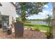 Cozy brick patio with lake view, comfortable chairs, and lush landscaping create a relaxing outdoor space at 645 Manor Rd, Maitland, FL 32751