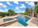 The backyard features a beautiful pool, spa, outdoor kitchen, fire pit, and lounge chairs for a resort-like experience at 645 Manor Rd, Maitland, FL 32751