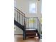 Staircase with wooden steps and black metal railing leads to a scenic lake view at 645 Manor Rd, Maitland, FL 32751