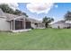 Expansive backyard featuring well-maintained lawn and screened-in patio enclosures at 682 Lexington Dr, Clermont, FL 34711