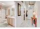 Bright bathroom featuring a single sink vanity with ample counter space, adjacent to the entryway of the home at 682 Lexington Dr, Clermont, FL 34711