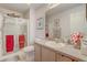 Bathroom featuring a glass-enclosed shower, toilet, vanity, and decorative mirror at 682 Lexington Dr, Clermont, FL 34711