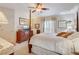 Spacious bedroom with a four-poster bed, ceiling fan, and large windows for natural light at 682 Lexington Dr, Clermont, FL 34711