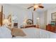 Bedroom with a four-poster bed, white walls, and ensuite bathroom entrance at 682 Lexington Dr, Clermont, FL 34711