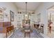 Vaulted ceiling dining room with traditional furniture, featuring tile flooring and a decorative rug at 682 Lexington Dr, Clermont, FL 34711