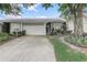 Charming single-story home with a two-car garage, featuring mature landscaping and a well-maintained lawn at 682 Lexington Dr, Clermont, FL 34711