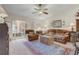 Comfortable living room featuring neutral carpet, ceiling fan, and access to the screened patio at 682 Lexington Dr, Clermont, FL 34711