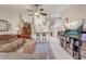 Open-concept living room with a ceiling fan, leading to the kitchen and other living spaces at 682 Lexington Dr, Clermont, FL 34711