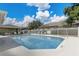 Community pool with lounge chairs and a covered picnic area on a sunny day at 682 Lexington Dr, Clermont, FL 34711