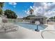 Outdoor community pool with basketball hoop, lounge chairs, and clear blue water at 682 Lexington Dr, Clermont, FL 34711