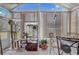 Enclosed sunroom featuring a tile floor, curtains and large windows to enjoy the backyard view at 682 Lexington Dr, Clermont, FL 34711