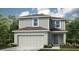 Charming two-story home featuring gray siding, a two-car garage, and lush landscaping at 7335 Capstone Dr, Groveland, FL 34736