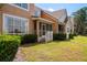 Backyard featuring a screened-in porch, lush lawn, and well-maintained landscaping at 7420 Cypress Grove Rd # 132, Orlando, FL 32819