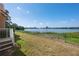 Scenic backyard view overlooking the lake, with a well-kept lawn at 7420 Cypress Grove Rd # 132, Orlando, FL 32819