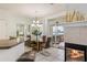 Lovely dining area with a modern chandelier, a fireplace and access to the patio at 7420 Cypress Grove Rd # 132, Orlando, FL 32819
