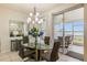 Chic dining area featuring a glass table, modern decor and serene lake views at 7420 Cypress Grove Rd # 132, Orlando, FL 32819