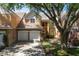 Charming exterior with stone accents, tile roof, two-car garage, and landscaped yard at 7420 Cypress Grove Rd # 132, Orlando, FL 32819