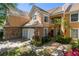 Charming exterior with stone accents, tile roof, two-car garage, and landscaped yard at 7420 Cypress Grove Rd # 132, Orlando, FL 32819