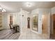 Spacious foyer with tile flooring, a decorative mirror, and a view into the home at 7420 Cypress Grove Rd # 132, Orlando, FL 32819