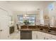 Kitchen boasts granite counters, white cabinetry, a view of the lake, and stainless steel appliances at 7420 Cypress Grove Rd # 132, Orlando, FL 32819