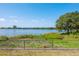 Picturesque lake view showcasing the water and a distant cityscape at 7420 Cypress Grove Rd # 132, Orlando, FL 32819