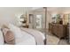 Spacious main bedroom features a four-poster bed, dresser, and view into main bathroom at 7420 Cypress Grove Rd # 132, Orlando, FL 32819