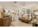 Inviting bedroom with a four-poster bed, wooden dresser, and plenty of natural light from windows at 7420 Cypress Grove Rd # 132, Orlando, FL 32819