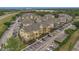 Aerial view showcasing apartment buildings with parking, landscaping, and easy access to surrounding roads at 8213 Claire Ann Dr # 108, Orlando, FL 32825