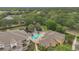 Aerial view of the community pool with lounge seating, palm trees, and well-manicured landscaping at 8213 Claire Ann Dr # 108, Orlando, FL 32825