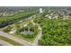 Scenic aerial view of apartments near a pond, green space, and a walking path at 8213 Claire Ann Dr # 108, Orlando, FL 32825