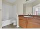 Well-lit bathroom with a shower-tub combo, wood vanity, and tiled floors at 8213 Claire Ann Dr # 108, Orlando, FL 32825