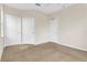 Spacious bedroom featuring plush carpeting, a ceiling fan, and multiple closets for ample storage at 8213 Claire Ann Dr # 108, Orlando, FL 32825