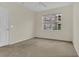 Bright bedroom featuring neutral walls, plush carpeting, a ceiling fan, and large windows for natural light at 8213 Claire Ann Dr # 108, Orlando, FL 32825